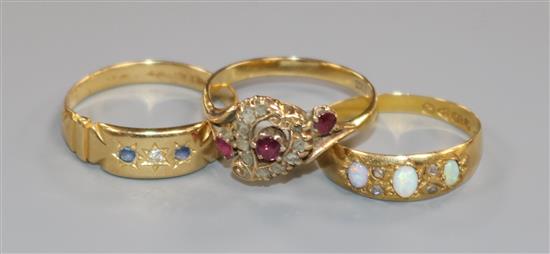 A Victorian 18ct gold, ruby and diamond openwork cluster ring and two other rings,